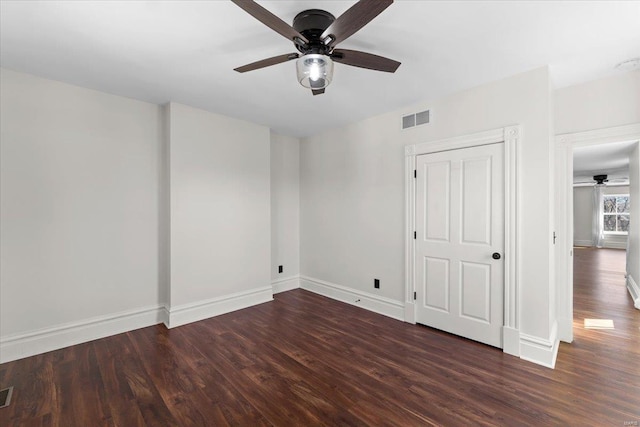 unfurnished bedroom featuring visible vents, baseboards, and wood finished floors