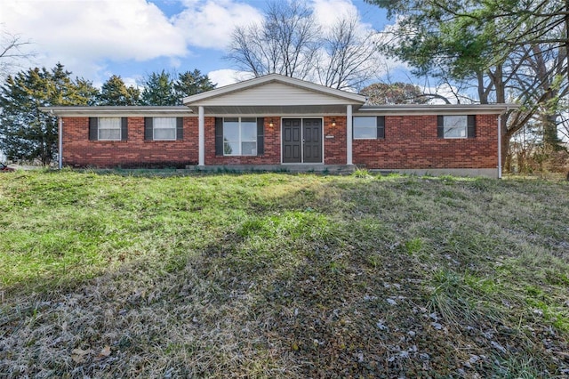 single story home featuring brick siding and a front yard