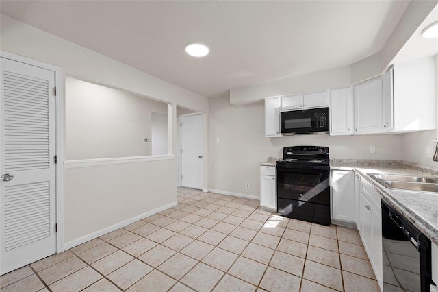 kitchen with black appliances, light countertops, light tile patterned flooring, white cabinetry, and a sink