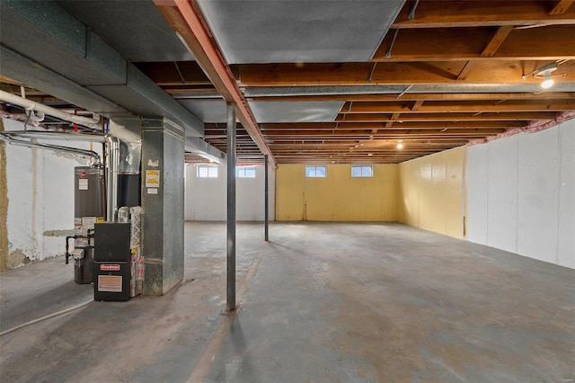 basement with water heater and heating unit