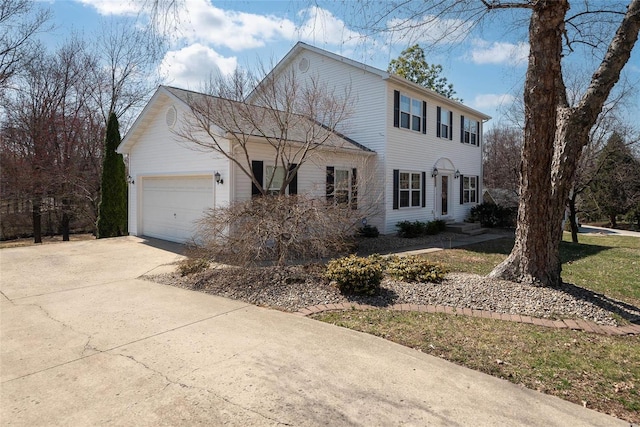 colonial inspired home with an attached garage, concrete driveway, and entry steps