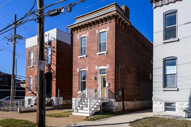 italianate house with brick siding and fence