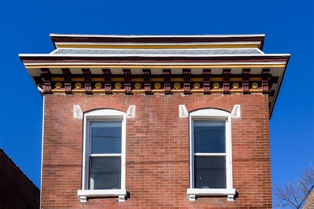 view of side of home featuring brick siding