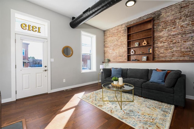 living room with visible vents, built in shelves, dark wood-style floors, and baseboards