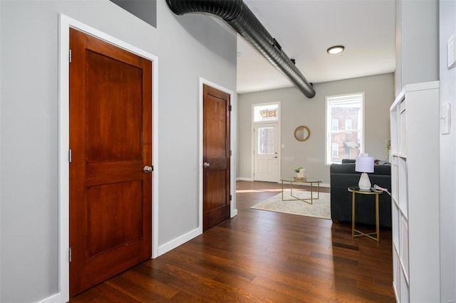 entryway with baseboards and dark wood-style flooring