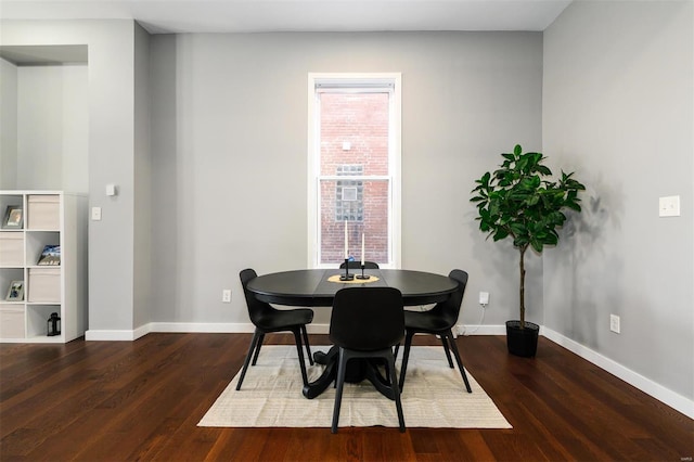 dining area featuring baseboards and wood finished floors