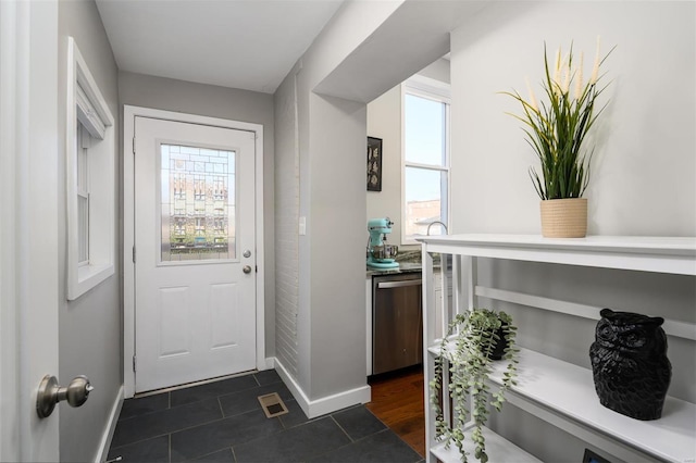 entryway featuring visible vents, baseboards, and a healthy amount of sunlight