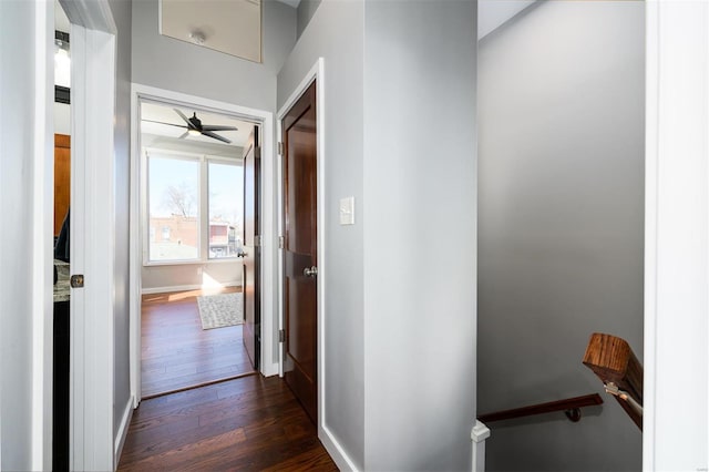 hall with dark wood-style floors and baseboards