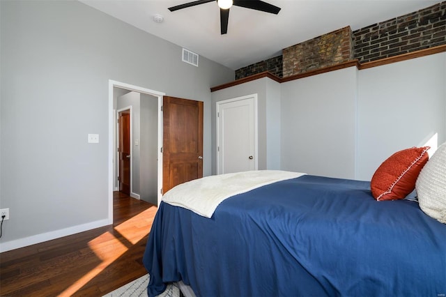 bedroom featuring a ceiling fan, wood finished floors, visible vents, baseboards, and a closet