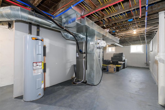 basement featuring heating unit and electric water heater