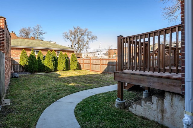 view of yard with a fenced backyard and a wooden deck