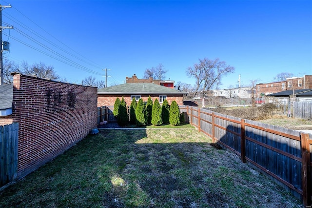 view of yard with a fenced backyard