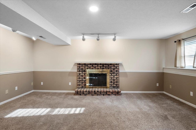 unfurnished living room featuring carpet, visible vents, and a textured ceiling