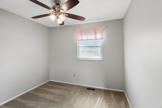 spare room featuring visible vents, baseboards, carpet, and ceiling fan