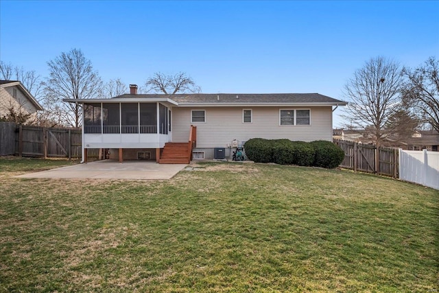 rear view of house featuring a gate, a fenced backyard, a sunroom, a patio area, and a lawn