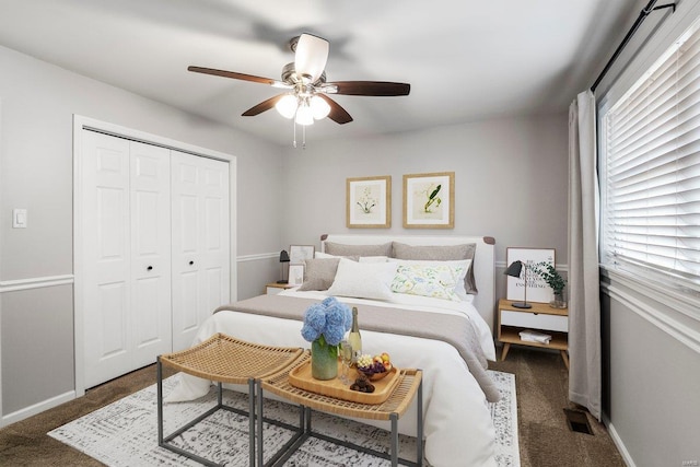 bedroom featuring a closet, visible vents, multiple windows, and ceiling fan