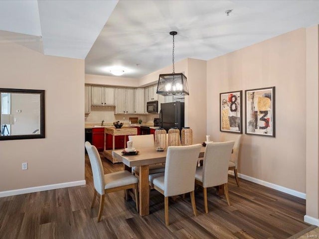 dining space featuring baseboards and dark wood-style flooring