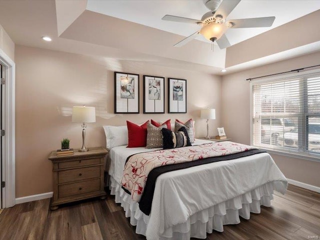 bedroom with ceiling fan, baseboards, recessed lighting, wood finished floors, and a raised ceiling