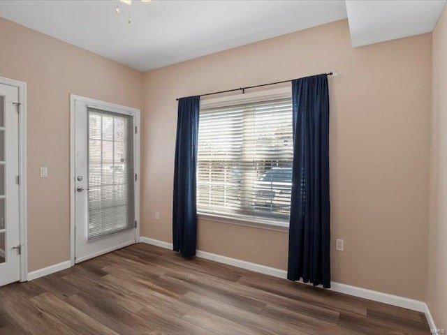 empty room featuring wood finished floors and baseboards