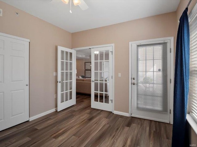 doorway featuring wood finished floors, french doors, and baseboards