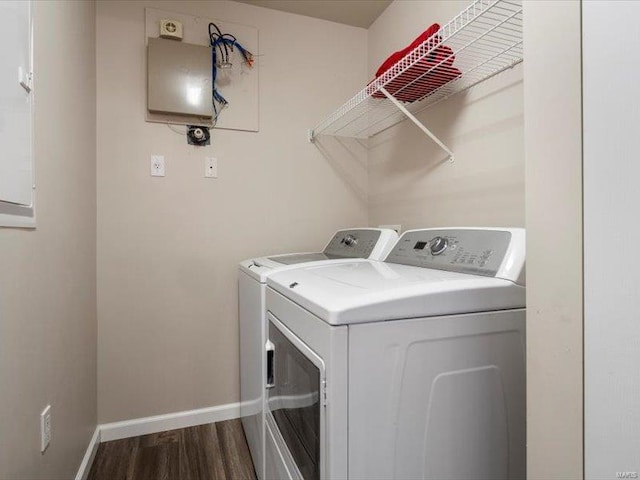 washroom featuring baseboards, dark wood-style flooring, laundry area, and washer and clothes dryer