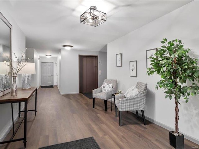 living area featuring baseboards and wood finished floors