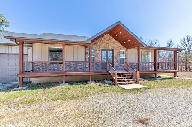 view of front of property with board and batten siding and roof with shingles