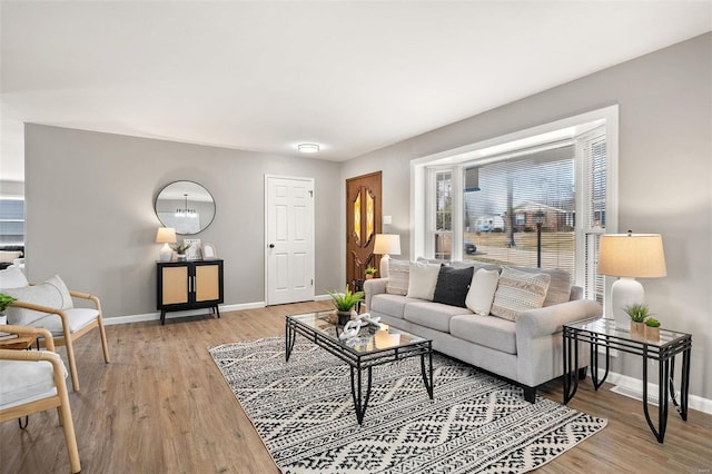 living area featuring light wood-type flooring and baseboards