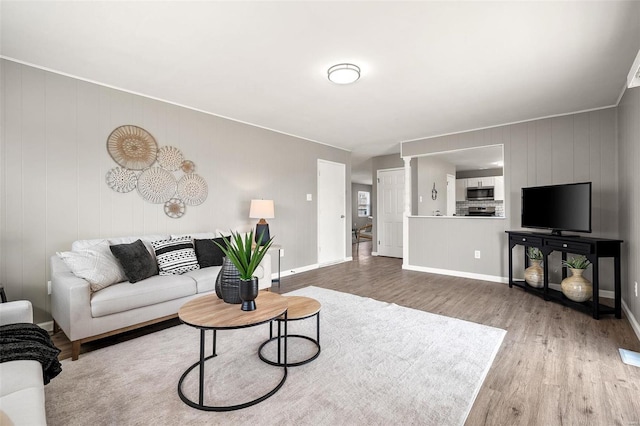 living room featuring baseboards and wood finished floors