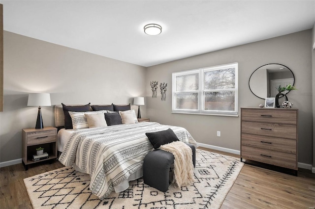 bedroom featuring baseboards and wood finished floors