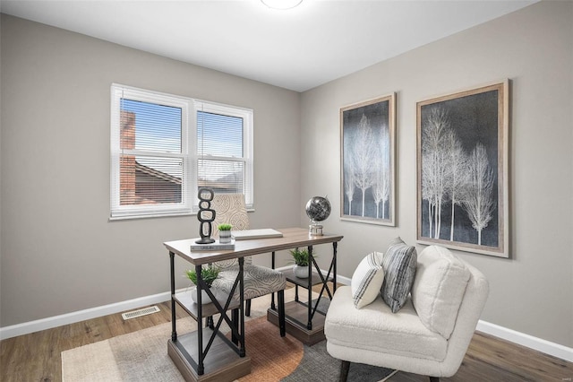 home office with visible vents, baseboards, and wood finished floors