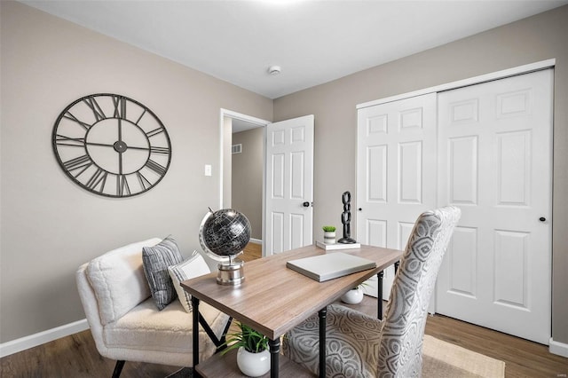 office area with visible vents, wood finished floors, and baseboards