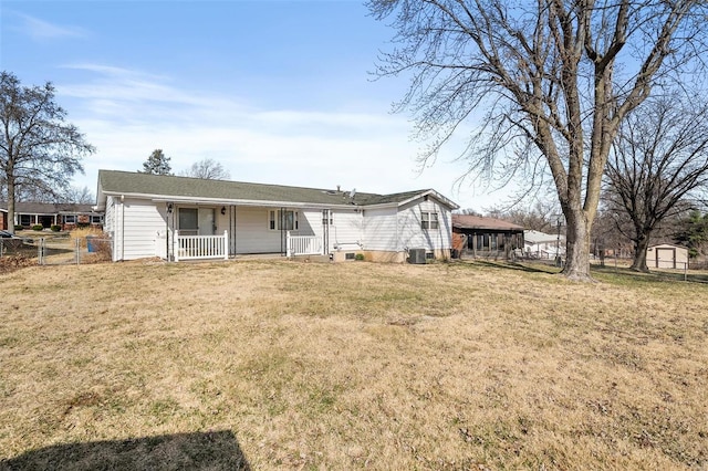 rear view of property with a porch, a yard, fence, and cooling unit