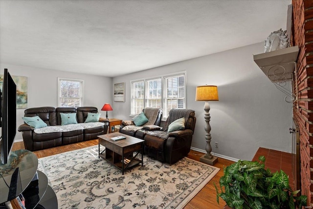 living area featuring baseboards and wood finished floors