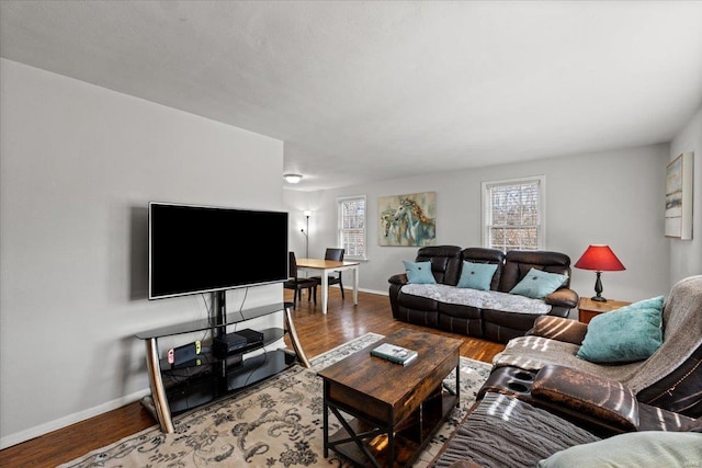 living room featuring baseboards and wood finished floors