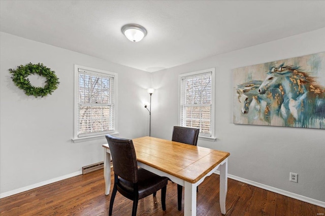 office area with a wealth of natural light, baseboards, baseboard heating, and wood finished floors