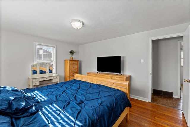 bedroom with wood finished floors and baseboards