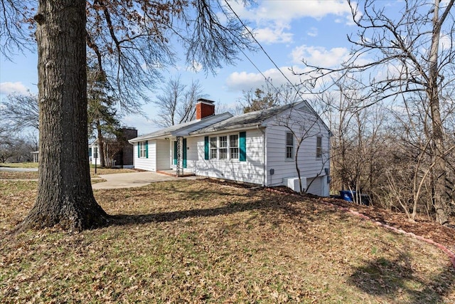 view of front of property with a front lawn and a chimney