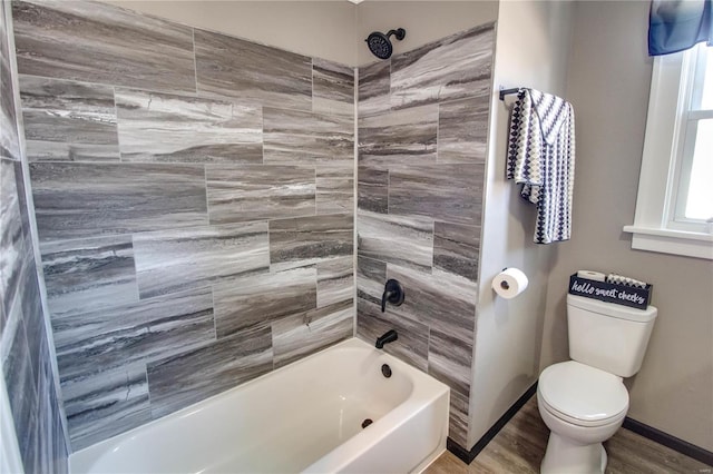 full bathroom featuring bathtub / shower combination, toilet, wood finished floors, and baseboards