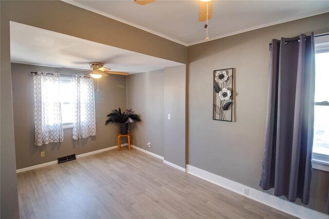 unfurnished room with visible vents, baseboards, a ceiling fan, and wood finished floors