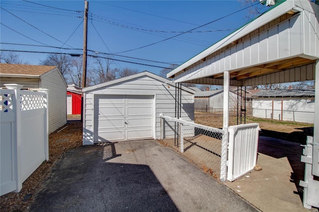 exterior space with aphalt driveway, a gate, and fence