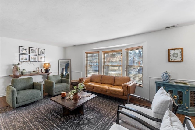 living room featuring visible vents and wood finished floors