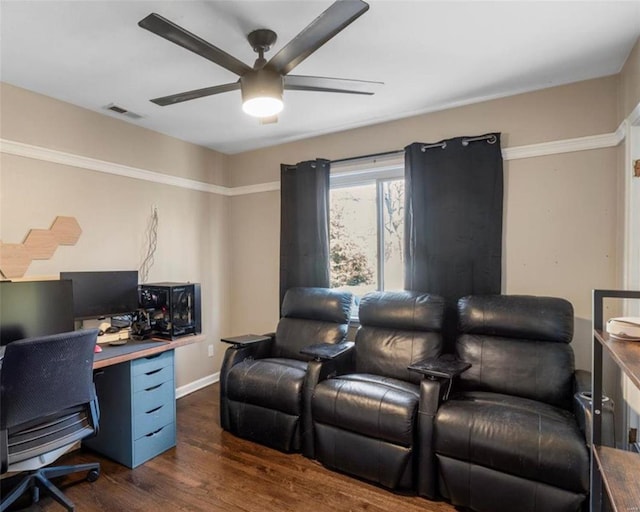 office space with dark wood finished floors, visible vents, baseboards, and a ceiling fan