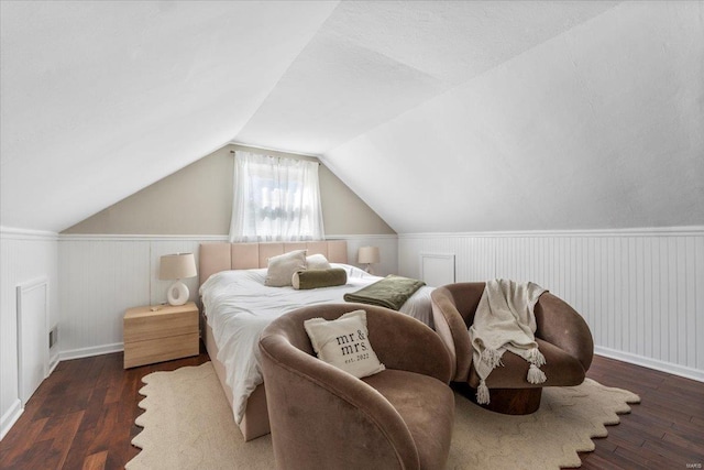 bedroom featuring lofted ceiling, visible vents, and wood-type flooring