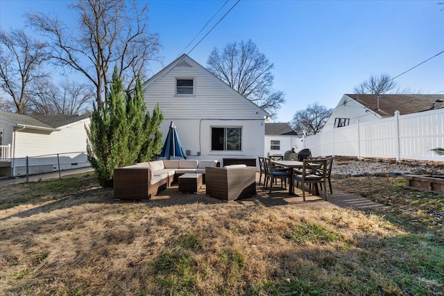 rear view of property featuring a fenced backyard and outdoor lounge area