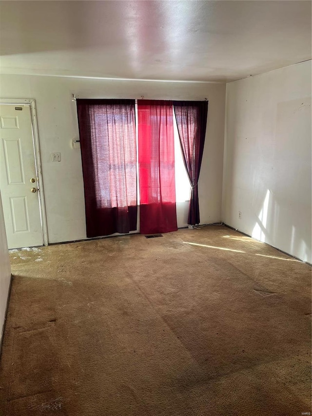 carpeted spare room with visible vents