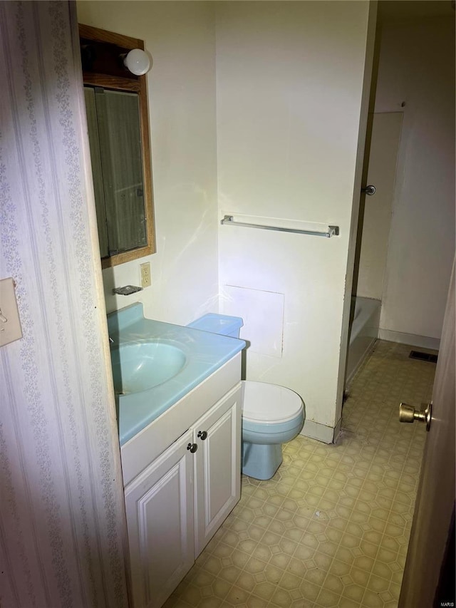 full bathroom featuring tile patterned floors, baseboards, toilet, and vanity