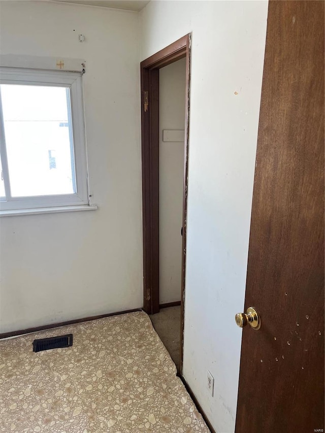 interior space featuring baseboards and visible vents