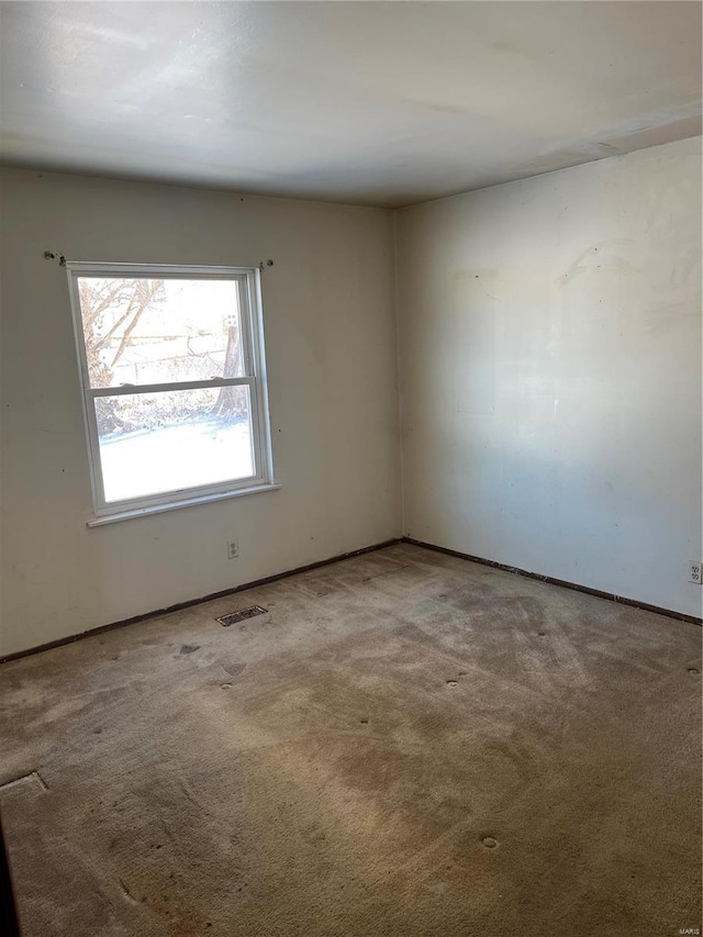 carpeted spare room with visible vents