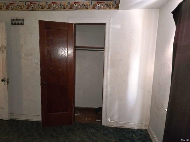 unfurnished bedroom featuring visible vents and a closet